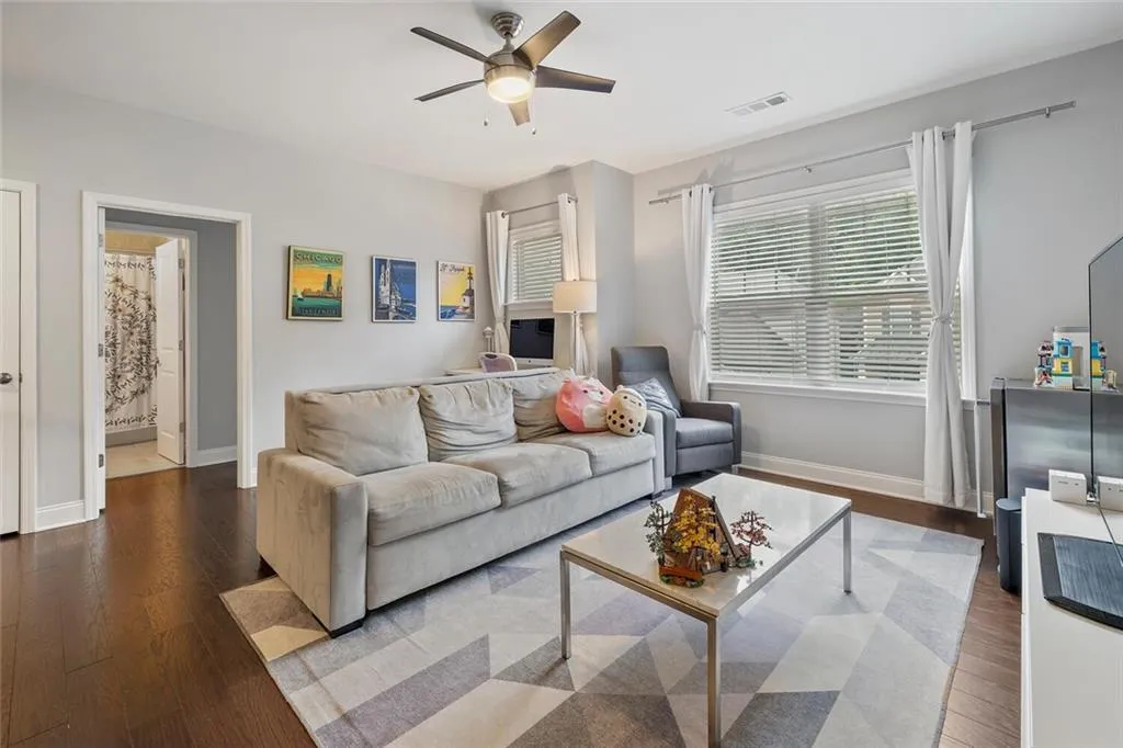 Loft featuring hardwood floors and ceiling fan