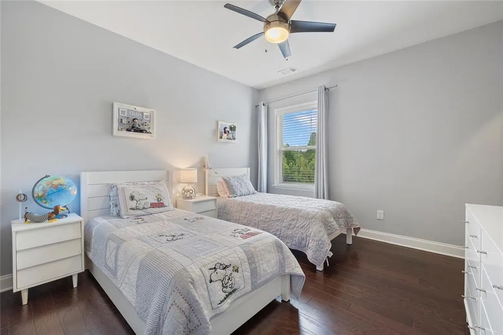 Bedroom with hardwood flooring and ceiling fan