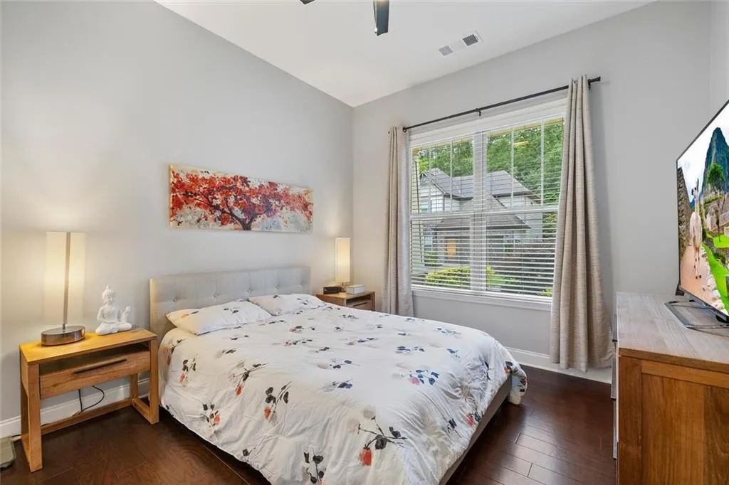 Bedroom featuring  hardwood flooring, ceiling fan, and lofted ceiling