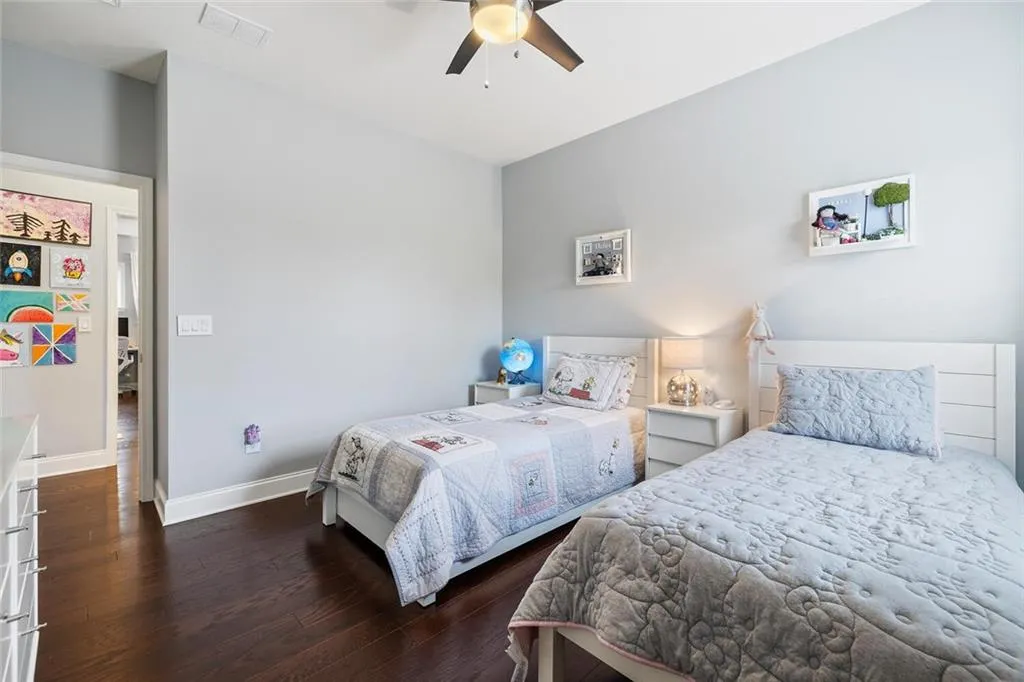 Bedroom featuring ceiling fan and hardwood flooring