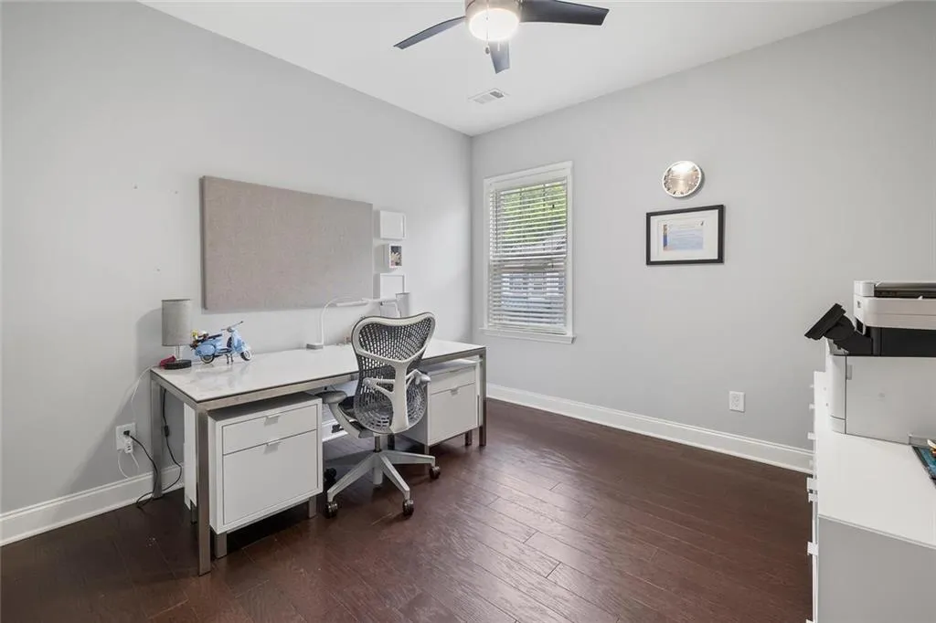 Office with ceiling fan and hardwood flooring