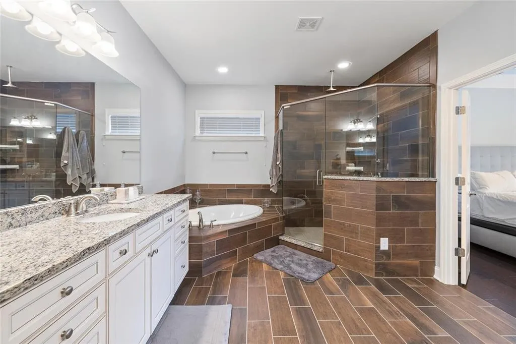 Bathroom featuring vanity and plus walk in shower