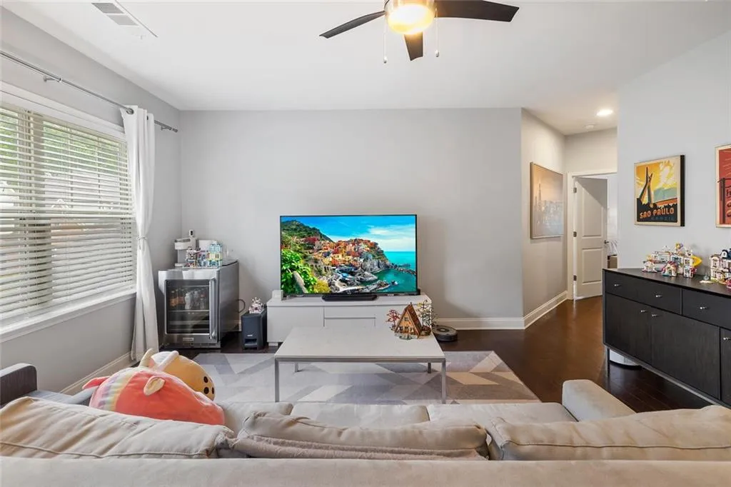 Loft featuring hardwood floors and ceiling fan