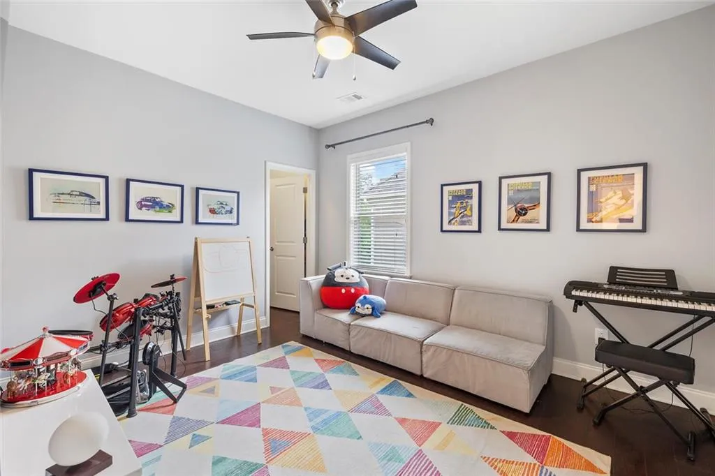 Bedroom featuring ceiling fan and hardwood flooring