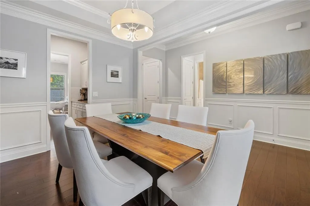 Dining room with crown molding, tray ceiling, and hardwood flooring