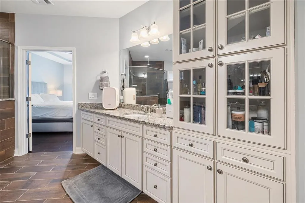 Bathroom with vanity, tile floors, and custom built-ins