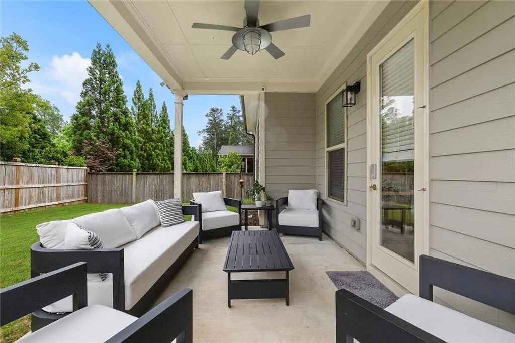 View of patio featuring ceiling fan and an outdoor living space