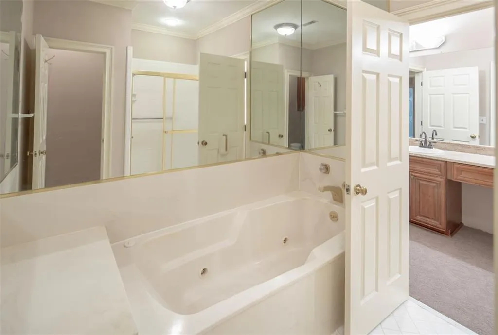 Bathroom featuring vanity, tile floors, and ornamental molding