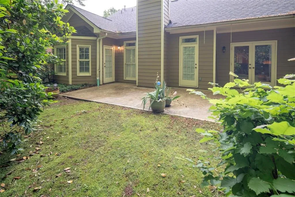 View of yard with french doors and a patio