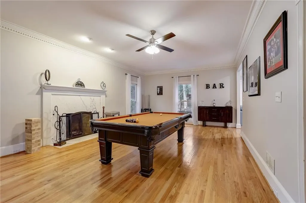 Game room with billiards, crown molding, ceiling fan, and light hardwood / wood-style flooring