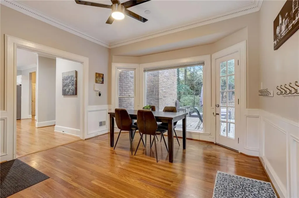 Dining space with light hardwood / wood-style floors, crown molding, and ceiling fan