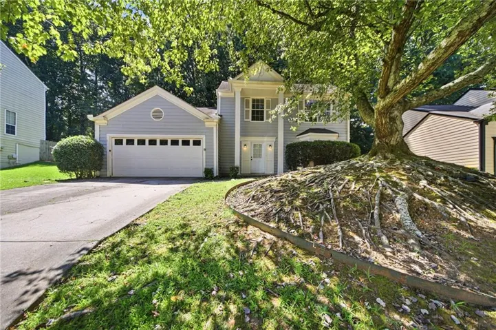 Light gray siding exterior with a white front door and covered entry
