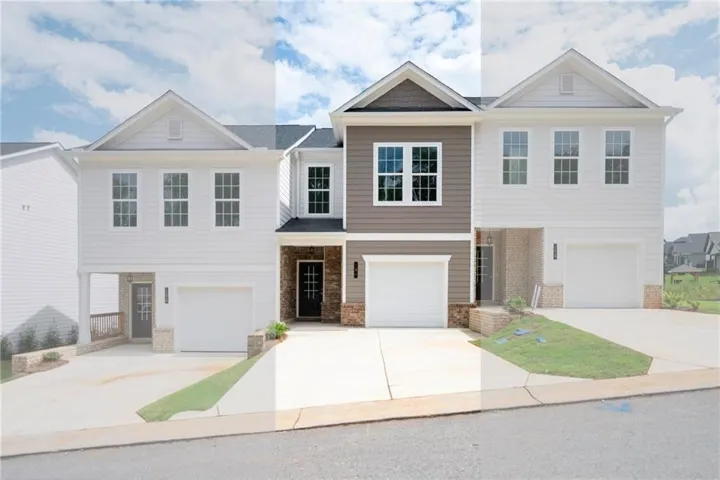 Modern multi-unit residence with distinct siding finishes, individual garage access, and covered entryways