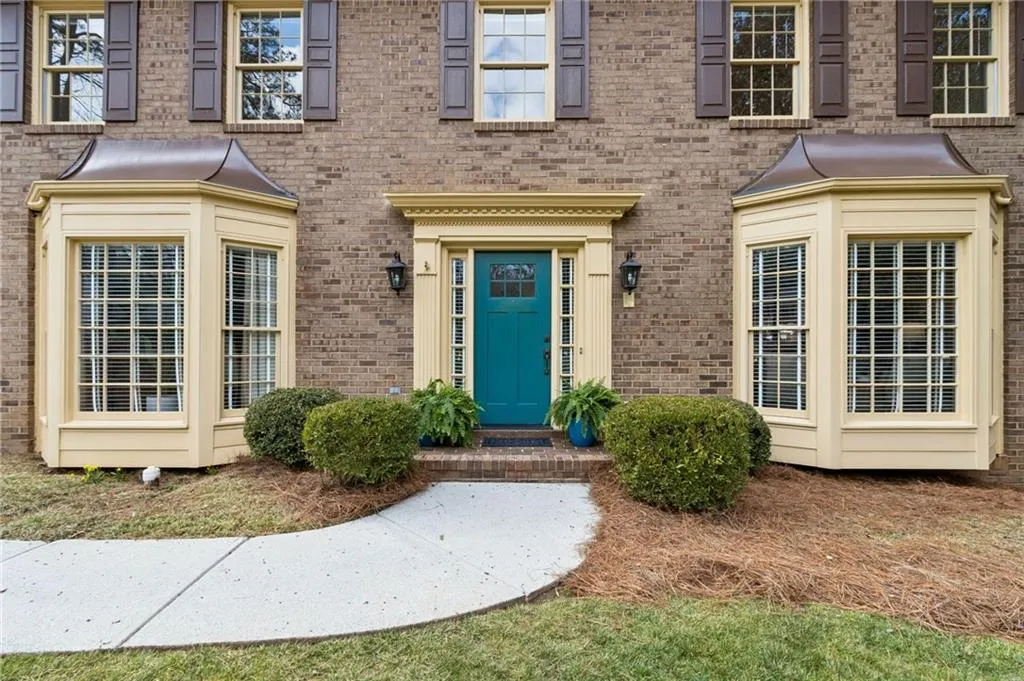 Entrance to property featuring brick siding