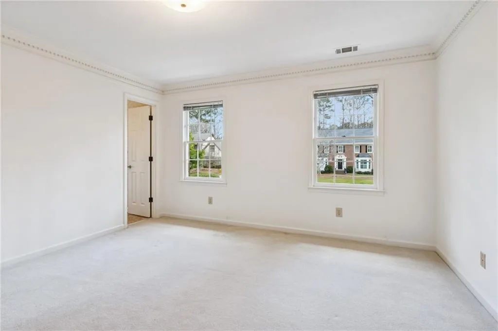 Unfurnished room featuring carpet floors and ornamental molding