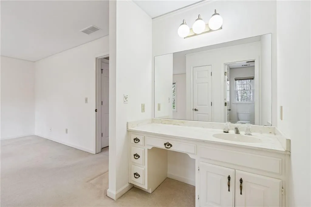 Full bath featuring vanity and light carpet