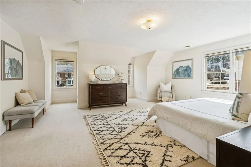 Bedroom featuring carpet flooring and baseboards