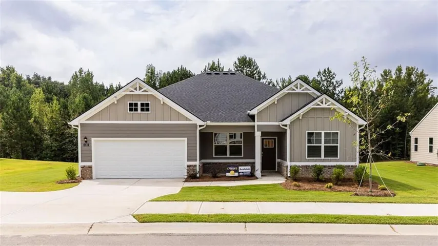 Contemporary single-story residence featuring light gray siding, a dark shingle roof, and white trim accents
