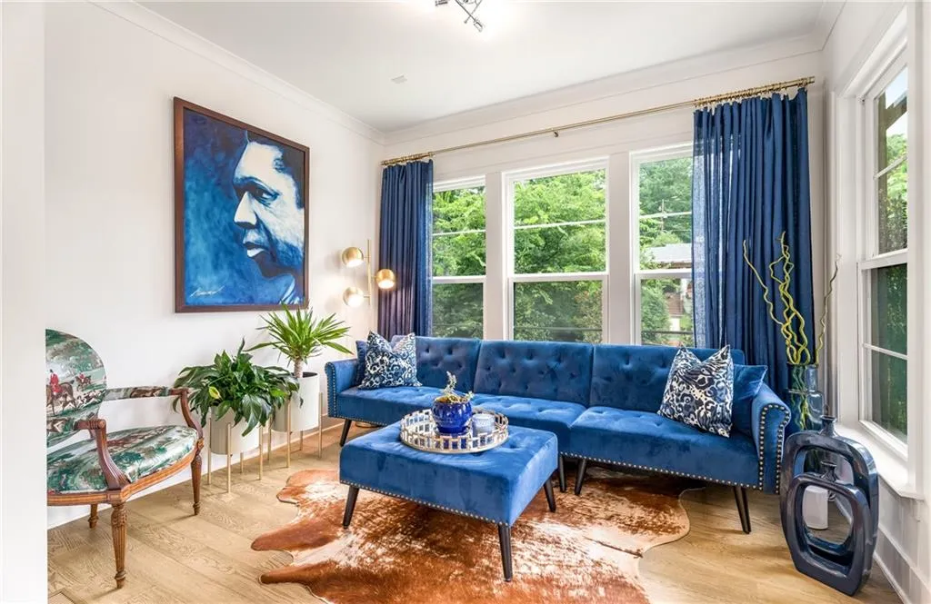 Living room with wood finished floors and ornamental molding