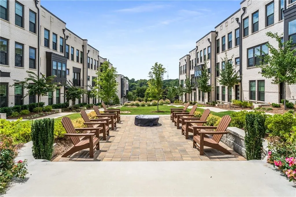 View of property's community featuring a patio area and a residential view