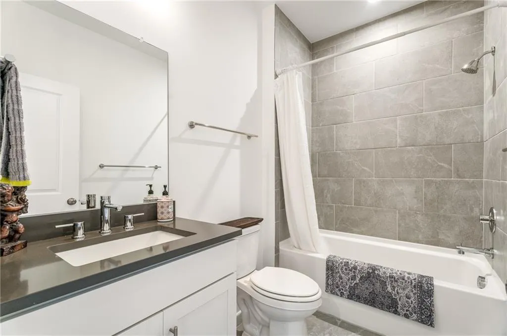 Bathroom with vanity and shower / tub combo with curtain