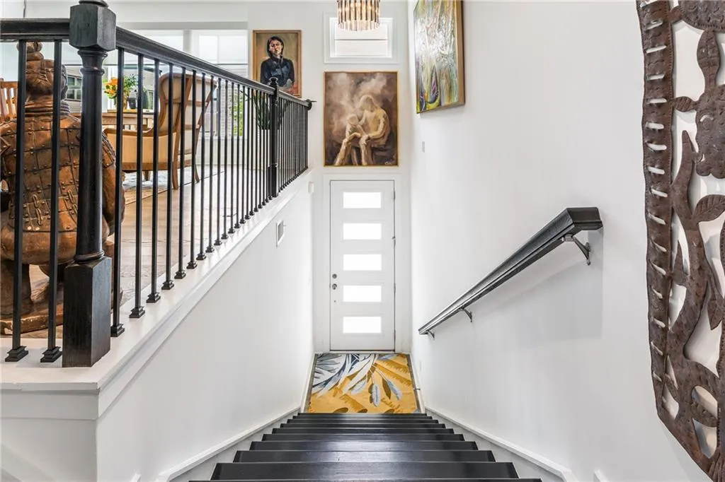 Stairway with plenty of natural light and wood finished floors