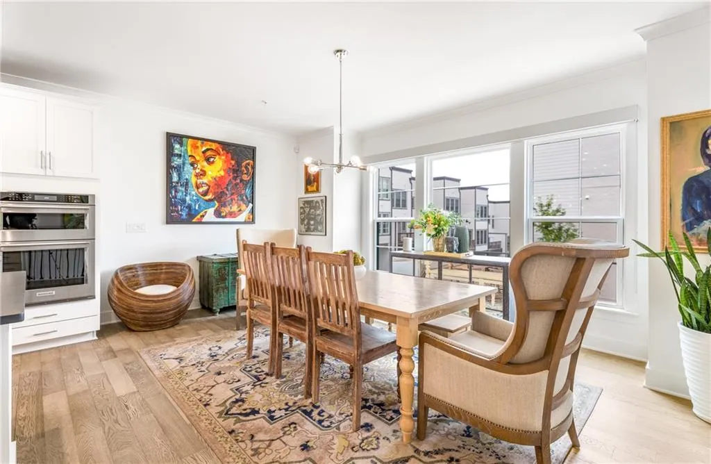 Dining room featuring light wood-type flooring, a chandelier, and ornamental molding