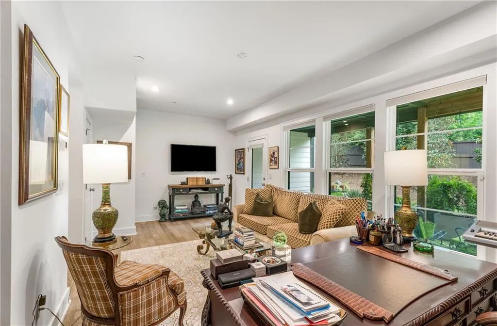 Living area with wood finished floors and recessed lighting