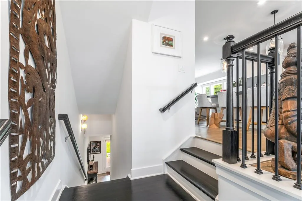Stairway featuring wood finished floors and a high ceiling