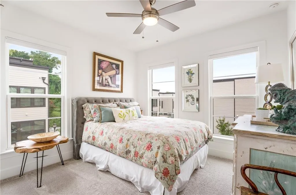 Bedroom featuring light colored carpet and ceiling fan