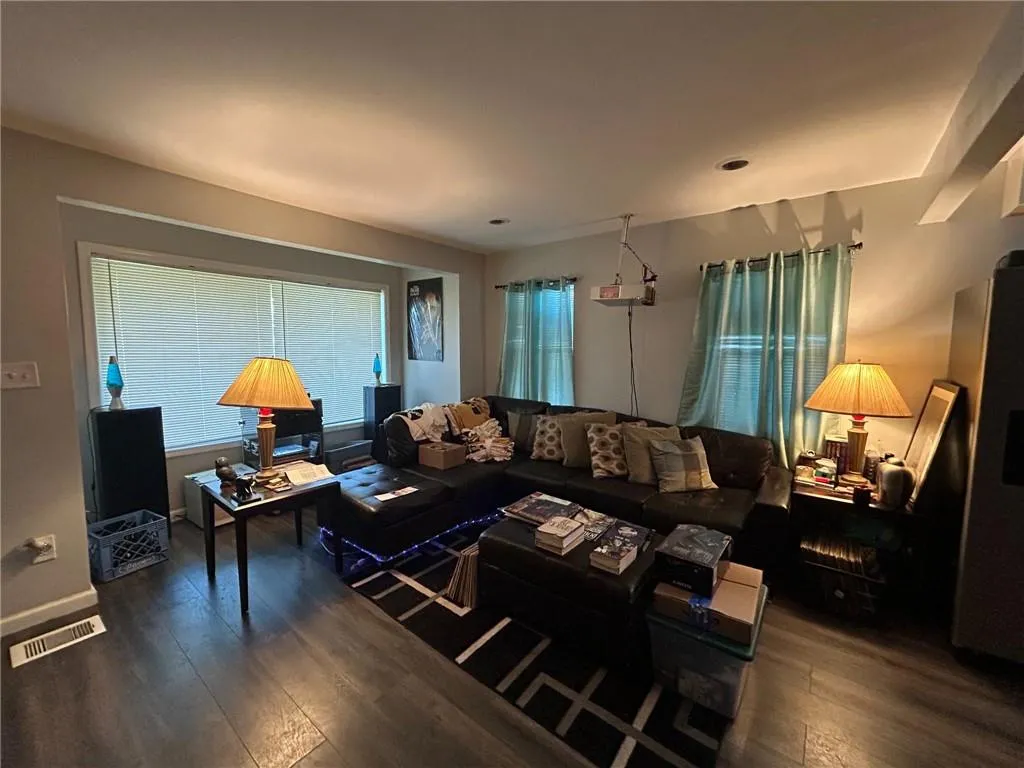 Living area featuring dark wood-style flooring