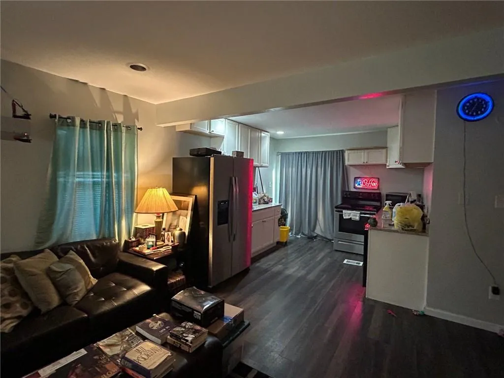 Living area featuring dark wood-type flooring
