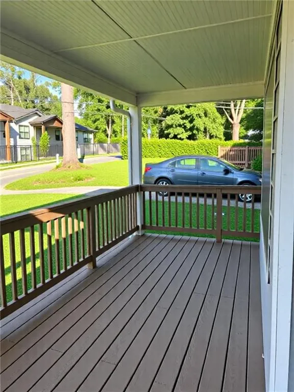 Wooden deck featuring a yard and a residential view