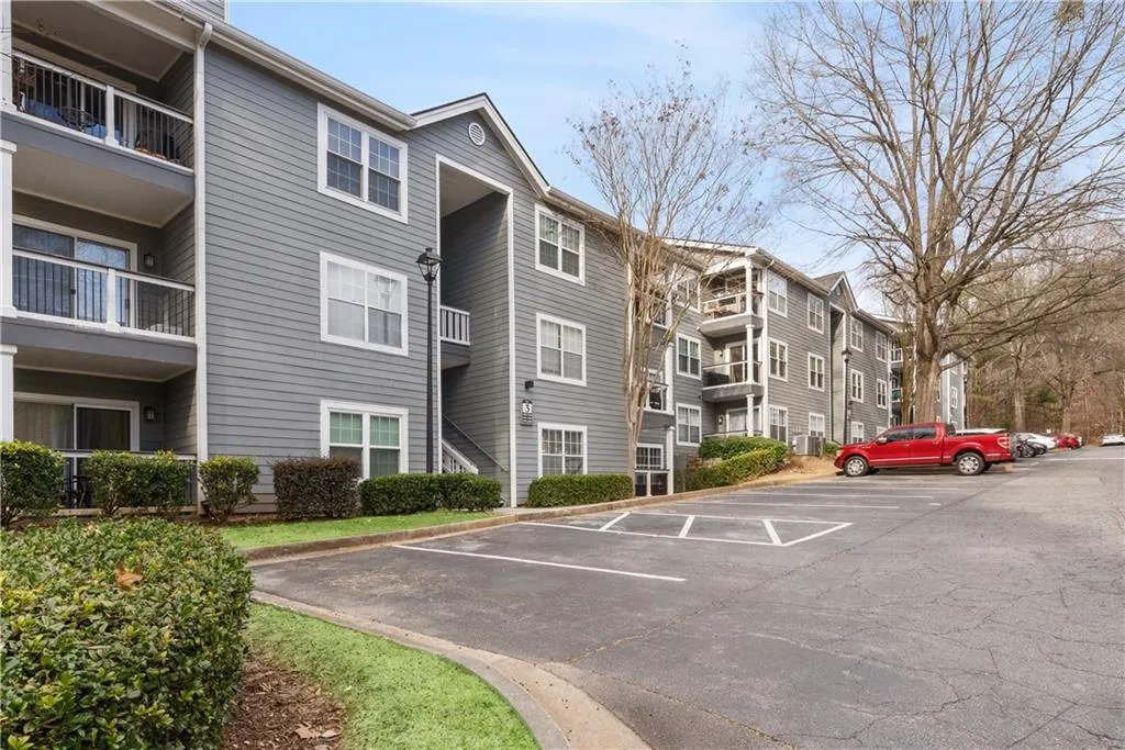 View of property with uncovered parking