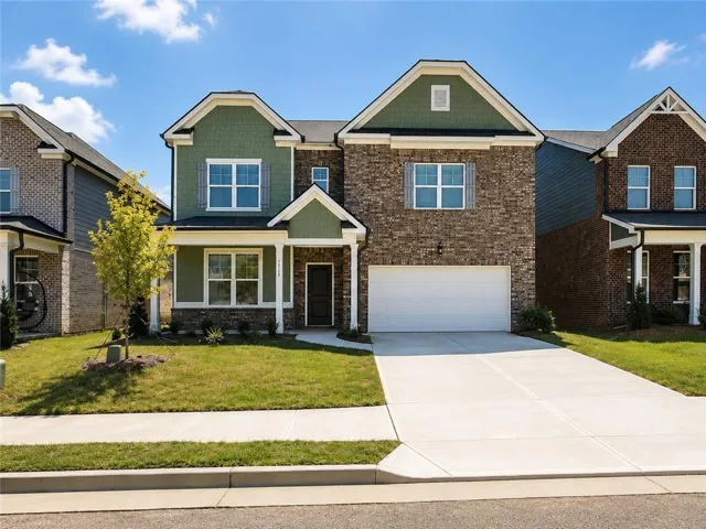 Two-story facade with brick and siding accents