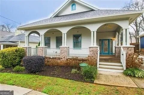 Inviting covered porch with arched columns and brick bases