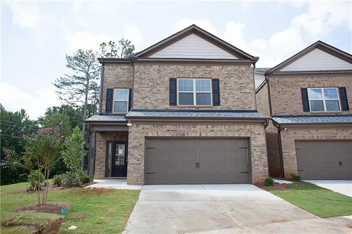 Brick facade townhome with a two-car garage