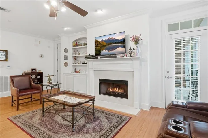 Spacious Family Room with Fireplace, Custom Built-Ins & Balcony access
