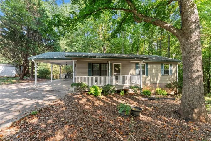 Single-level residence with a covered front porch featuring white railings