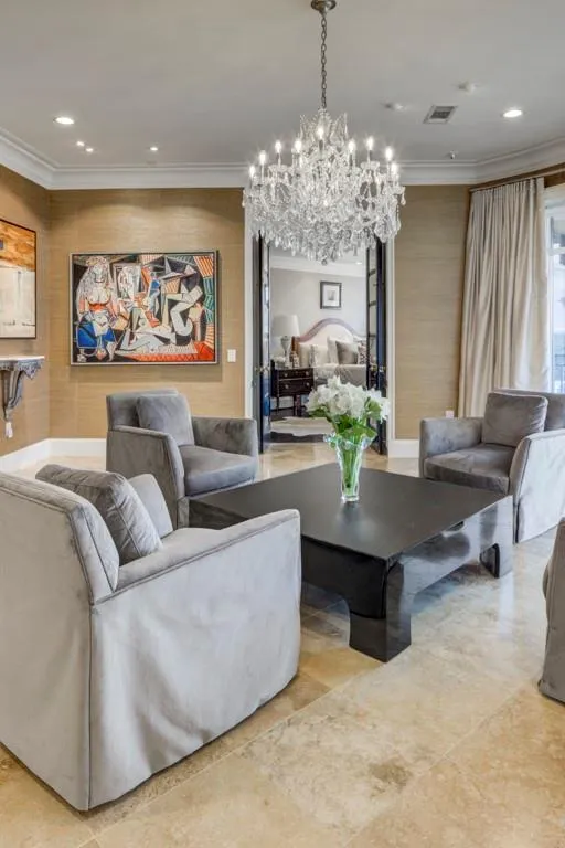 Elegant conversation area with primary suite discreetly located off to the left - long range views and access to large private balcony.