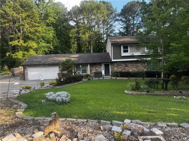 Stone veneer and siding exterior with a two-car garage
