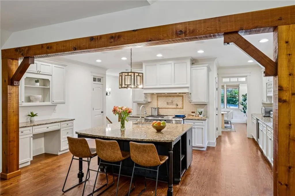 Timber trimmed accents from kitchen to the 2 story living room.