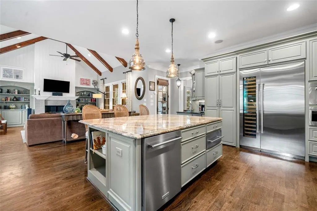 Kitchen features Warming Drawer, Dual Dishwashers, SubZero Fridge with Wine Column, Hidden Walk-in Pantry, Icemaker, Steam Oven, and Drawer Microwave