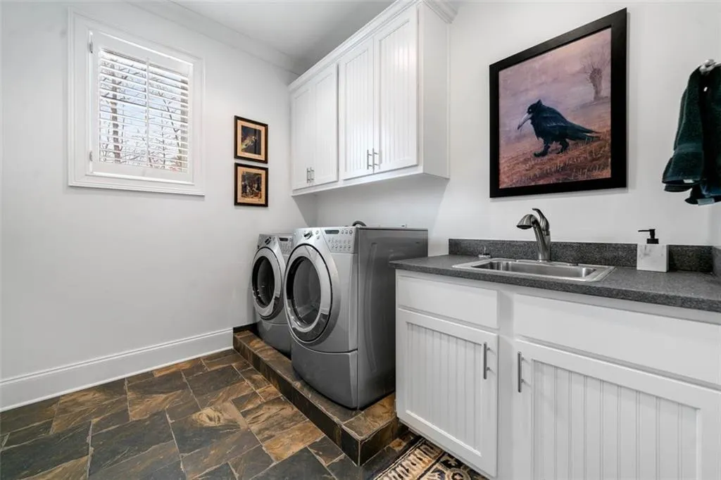 Second Laundry Room with Sink and Plenty of Storage on Second Level