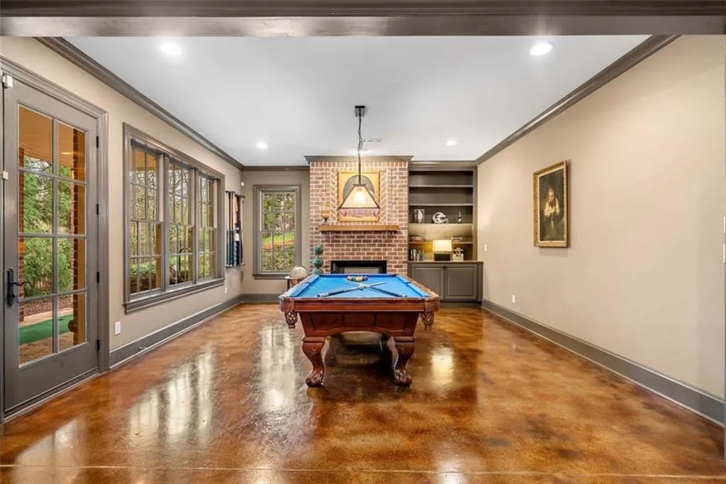 Terrace Level Rec Room with Fireplace and Built-ins offers the ideal Space for Billiards. Walk-out to Backyard
