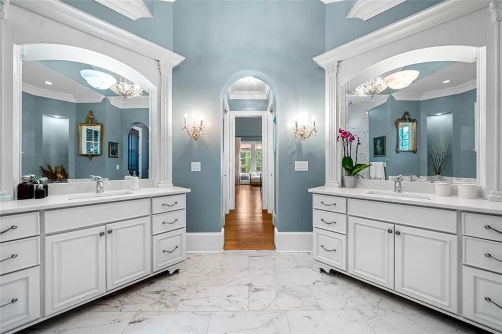 Primary Bath Features Double Vanities with Storage. View looking into Primary Bedroom