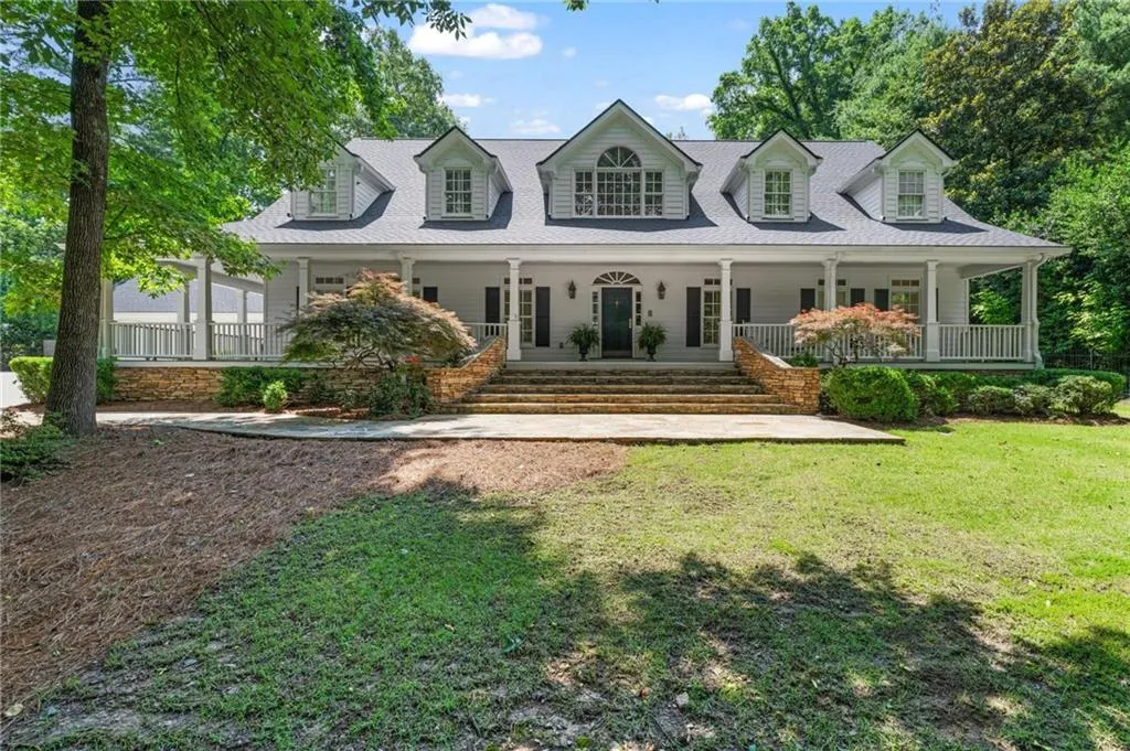 Nestled on a lush, tree-lined lot, this classic home blends elegance and warmth just moments from the heart of the city.