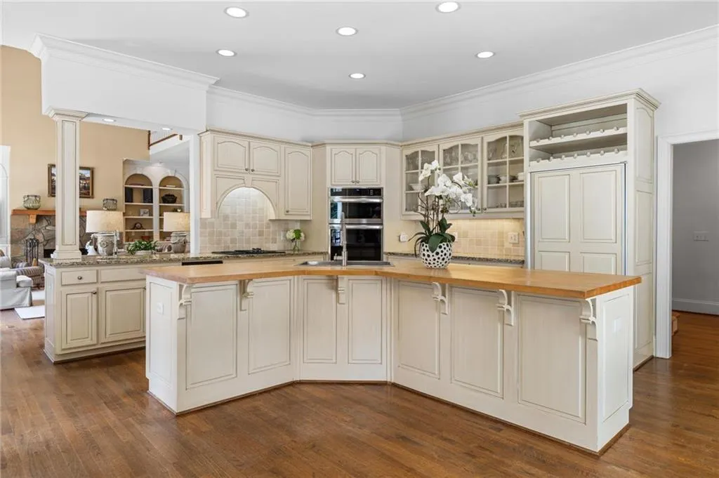 Kitchen with island has new oven/microwave combo and new dishwasher.