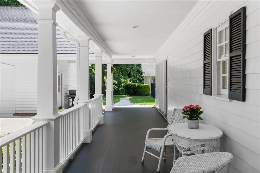 Side porch with garage to the left and guest house straight ahead. Kitchen entry ahead on right.