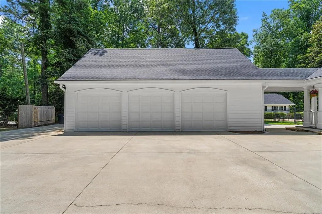 3-car detached garage with finished rec room, bath and kitchen above. And a new roof!